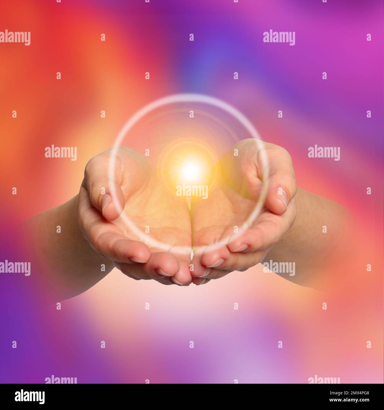 Woman holding concentrated healing energy in her hands, closeup Stock Photo