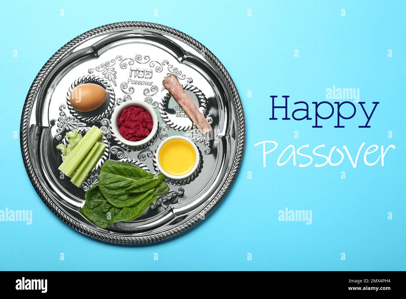 Passover Seder plate (keara) with symbolic meal on light blue