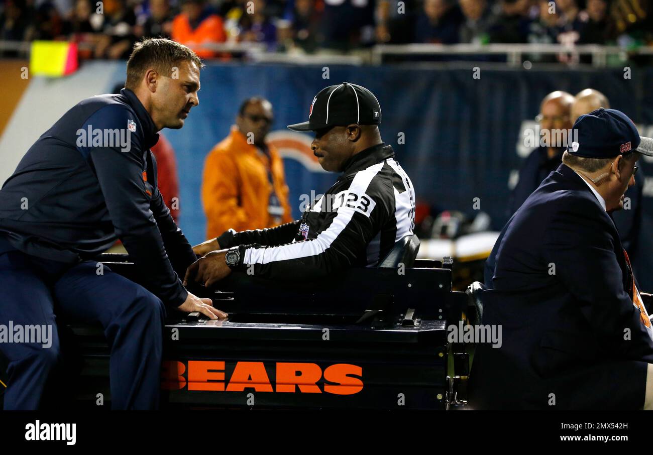 Head linesman Ed Walker is carted off the field after being injured