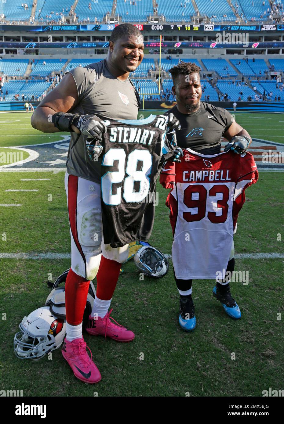 Carolina Panthers Jonathan Stewart right and Arizona Cardinals Calais Campbell left exchange jerseys after an NFL football game in Charlotte N.C. Sunday Oct. 30 2016. AP Photo Bob Leverone Stock Photo...