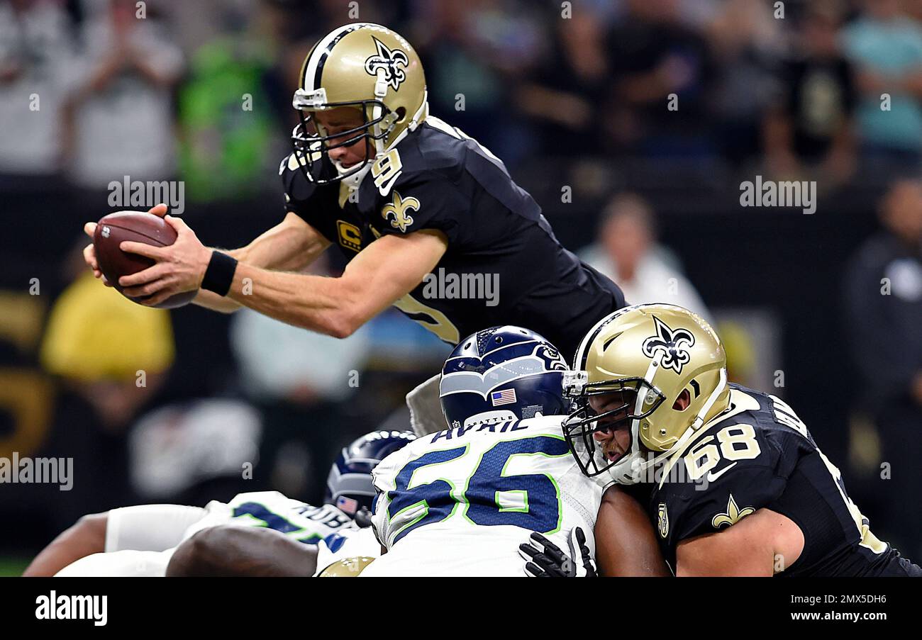 New Orleans Saints quarterback Drew Brees (9) dives over the pile for a  touchdown in the first half of an NFL football game against the Seattle  Seahawks in New Orleans, Sunday, Oct.