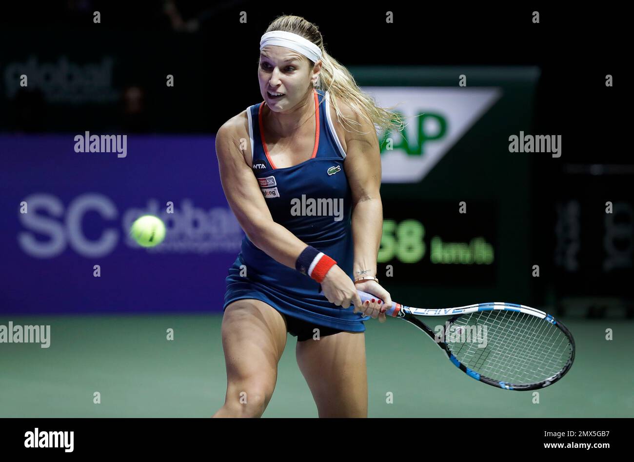 Dominika Cibulkova of Slovakia makes a backhand return to Angelique Kerber  of Germany during their women's final match at the WTA tennis tournament in  Singapore, Sunday, Oct. 30, 2016. (AP Photo/Wong Maye-E