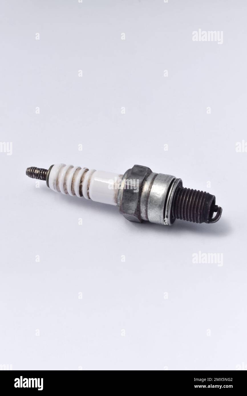 Used motorcycle spark plug isolated on white background. Stock Photo
