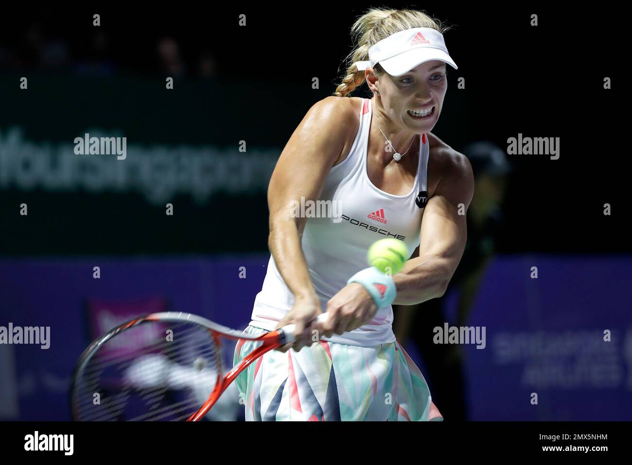Angelique Kerber of Germany makes a backhand return against Agnieszka  Radwanska of Poland during their singles match at the WTA tennis tournament  in Singapore, Saturday, Oct. 29, 2016. (AP Photo/Wong Maye-E Stock