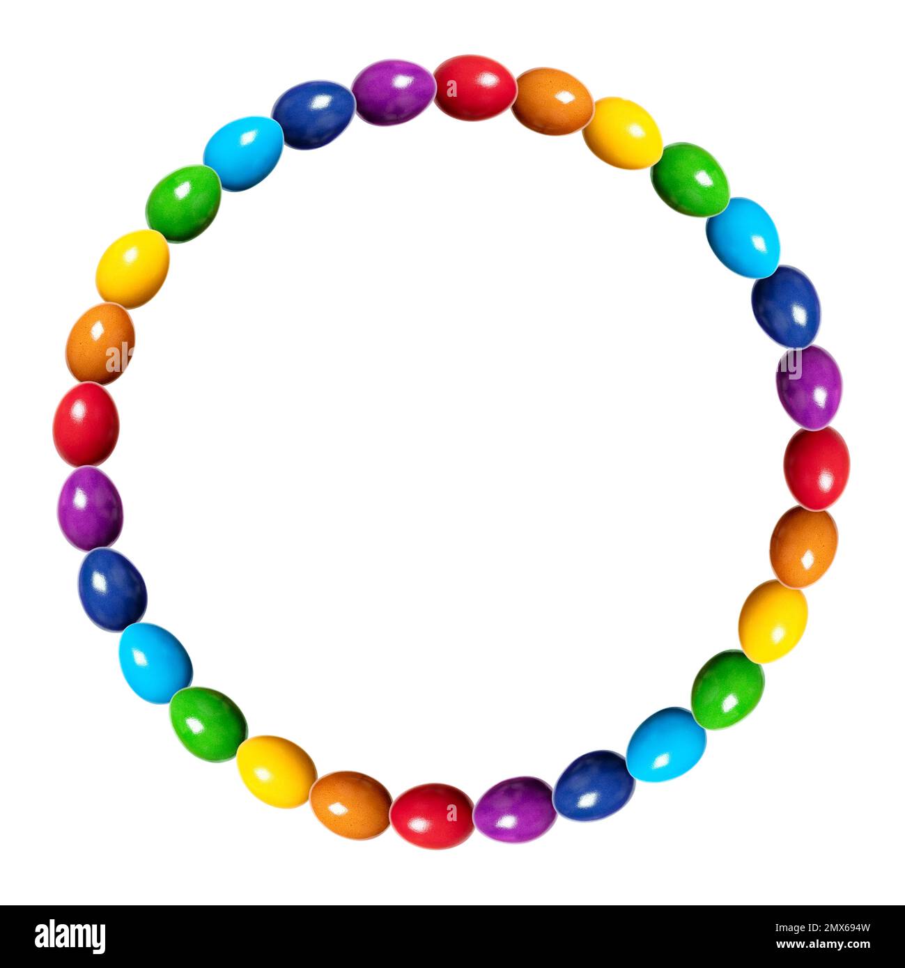 Circle border made of rainbow colored eggs. Circular frame, made of multi colored, dyed chicken eggs. Traditionally used during Easter time as a gift. Stock Photo