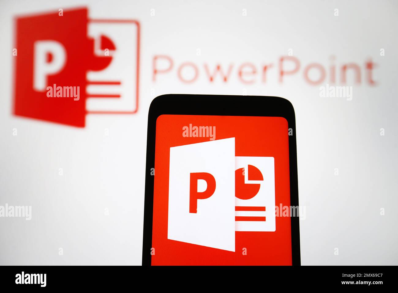 In this photo illustration, Microsoft PowerPoint logo of a software is seen on a smartphone and a pc screen. Stock Photo