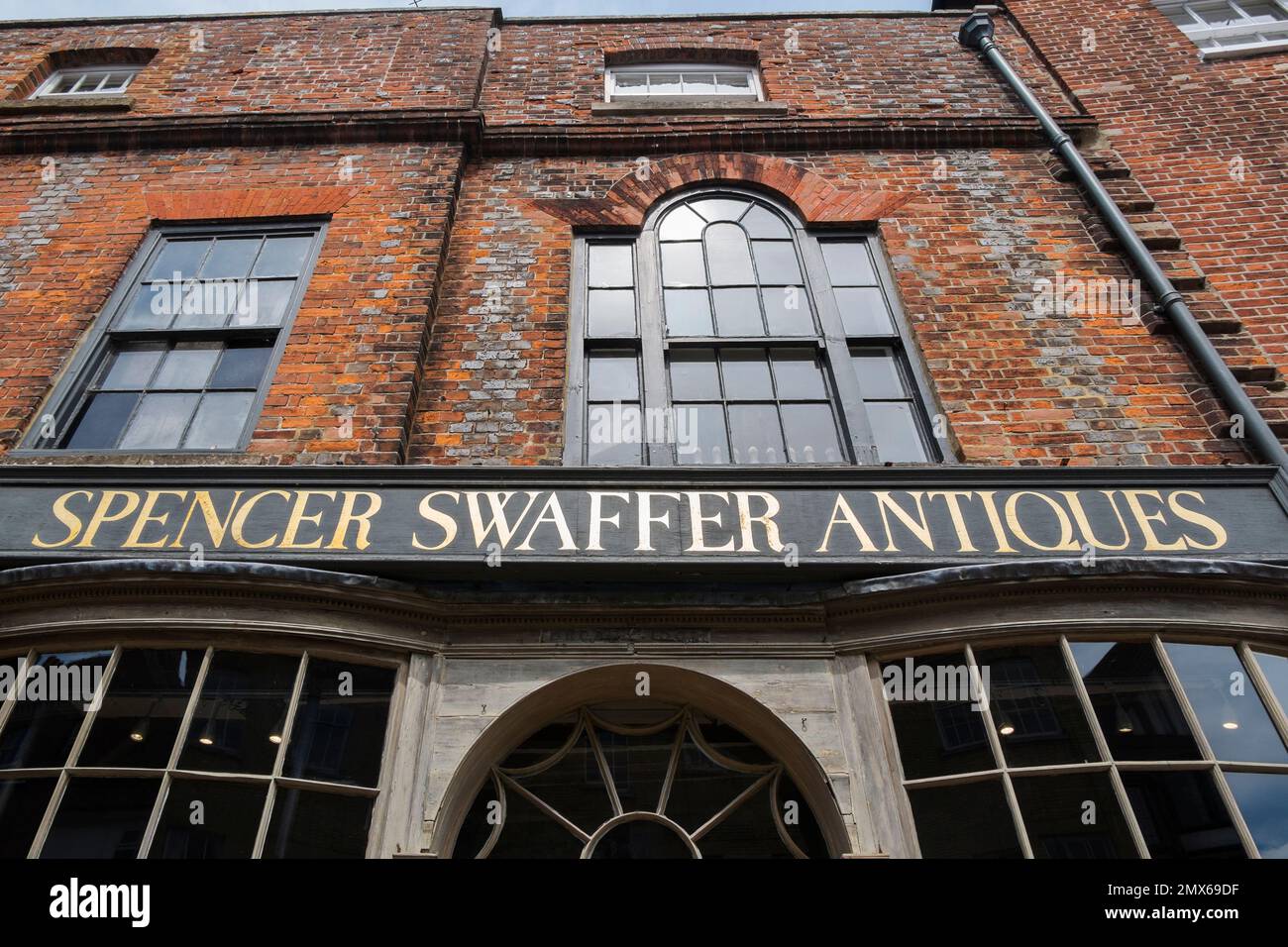 The shopfront of Spencer Swaffer, an eclectic antique shop on the High Street in Arundel, West Sussex, UK Stock Photo