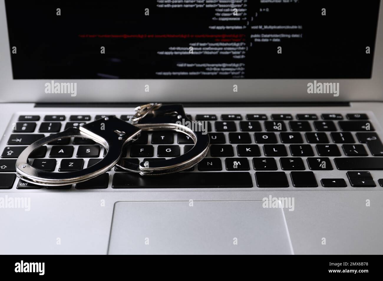 Handcuffs on modern laptop, closeup. Cyber crime Stock Photo - Alamy