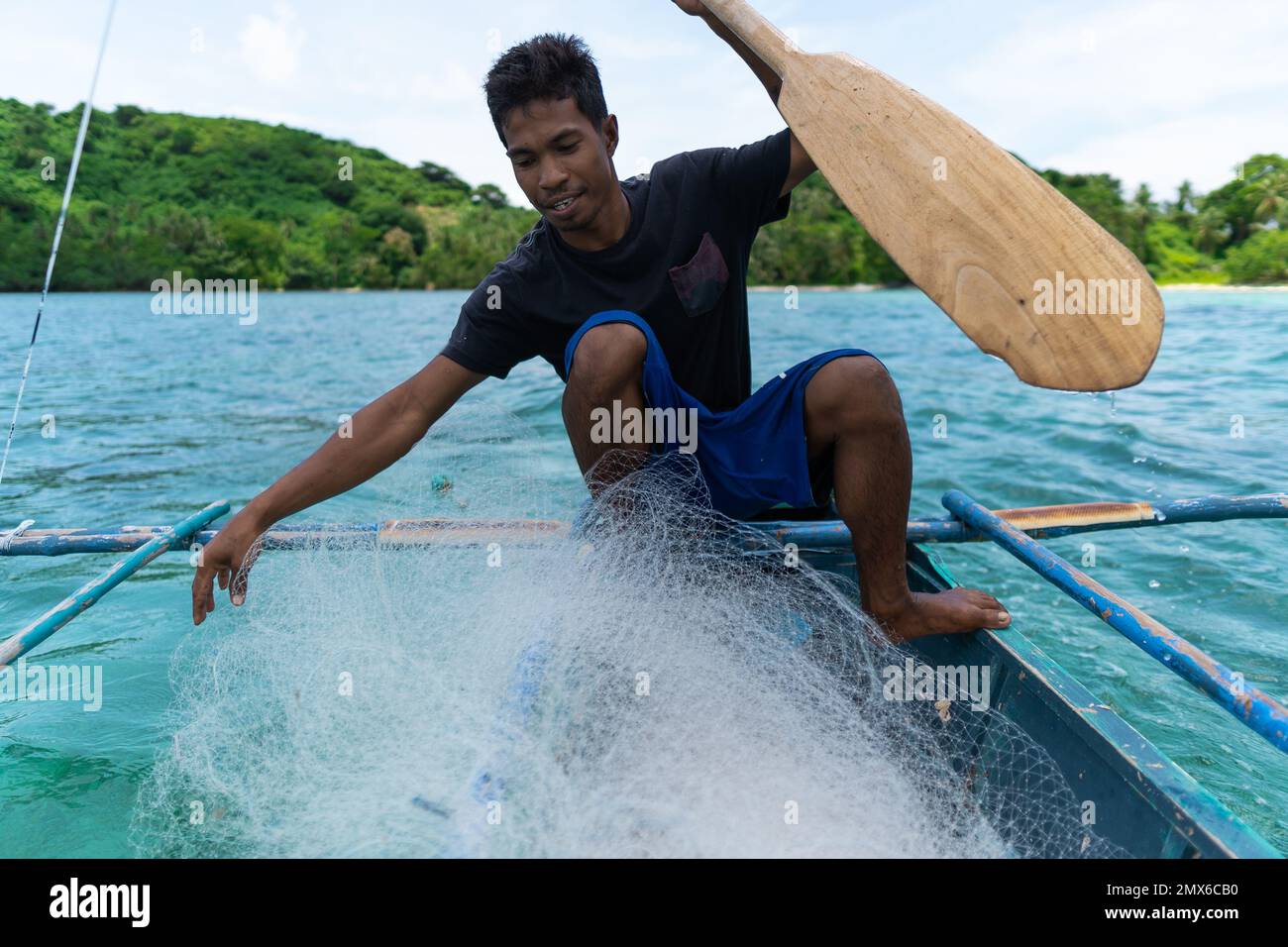 young filipino fisherman preparing fishing net on his boat, philippines islands, real people, lifestyle Stock Photo