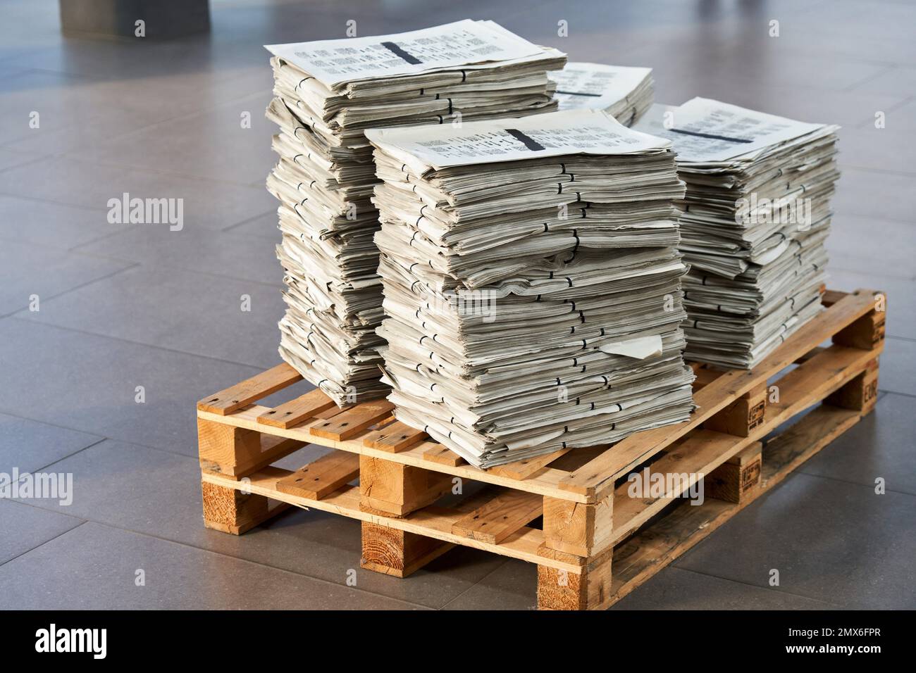 Newspapers in a pallet would generally be grouped and shrink-wrapped together for secure transportation. Depending on the volume of newspapers, the Stock Photo