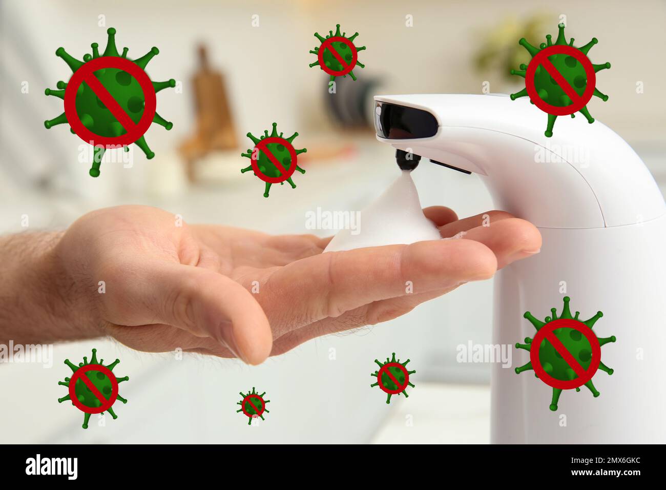 Man using automatic soap dispenser indoors, closeup. Washing hands during coronavirus outbreak Stock Photo