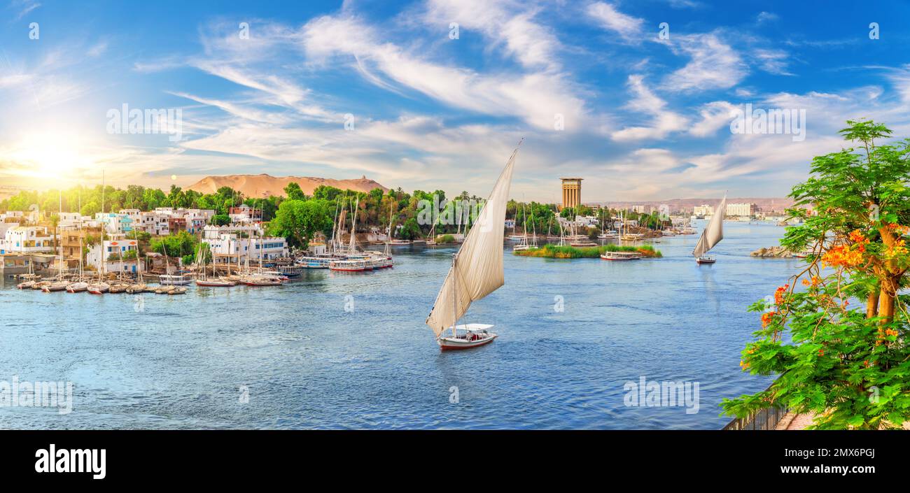 Beautiful Nile scenery of the sailboats and traditional villages of Aswan city, Egypt. Stock Photo