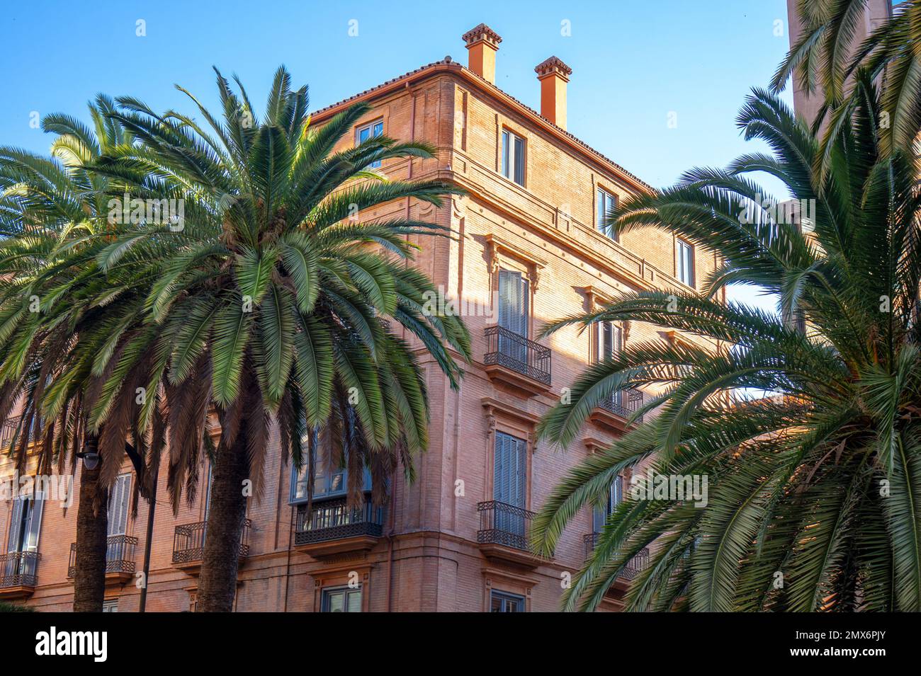 Decorated exteriours residental buildings in Malaga city, Andalusia, Spain with palm trees , Stock Photo