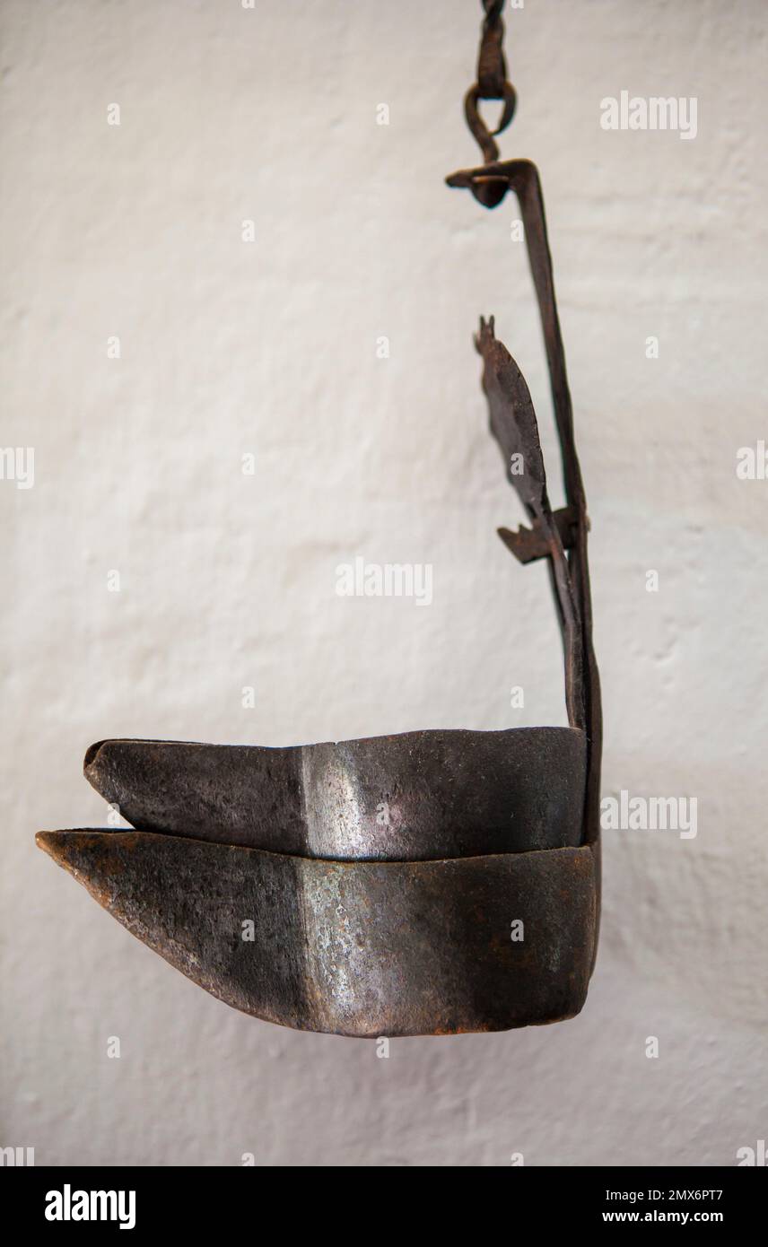 Antique iron oil lamp. Country style. Selective focus. Stock Photo