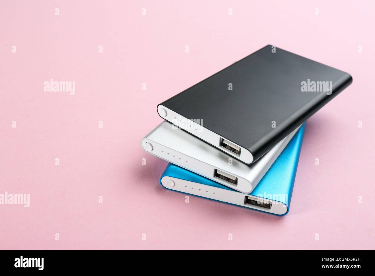 Modern external portable chargers on pink background Stock Photo Alamy