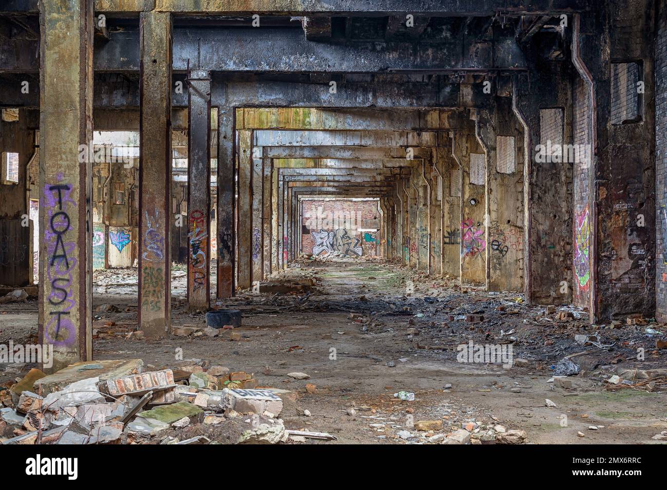 Messy abandoned factory warehouse. Creepy industrial hall Stock Photo