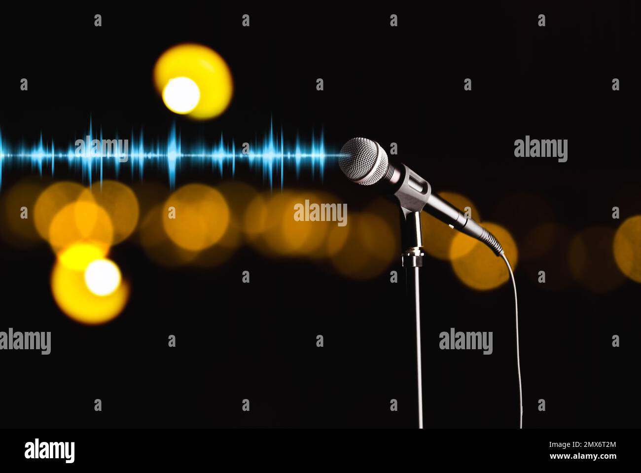 Microphone and radio wave on dark background, bokeh effect Stock Photo