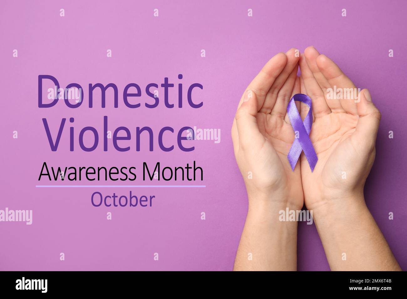 Woman holding purple ribbon on lilac background, top view. Symbol of Domestic Violence Awareness Stock Photo