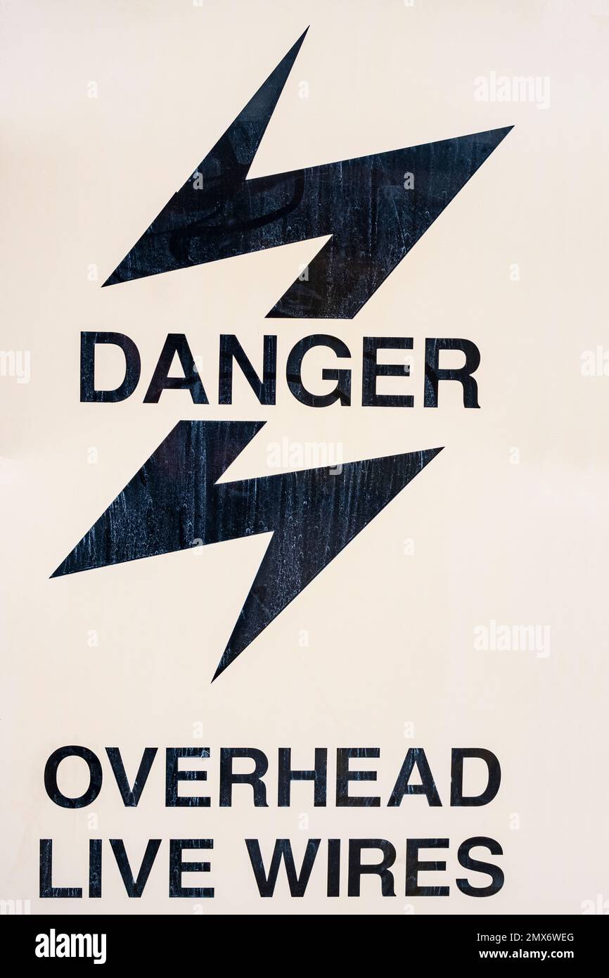 Danger overhead live wires warning sign UK Stock Photo