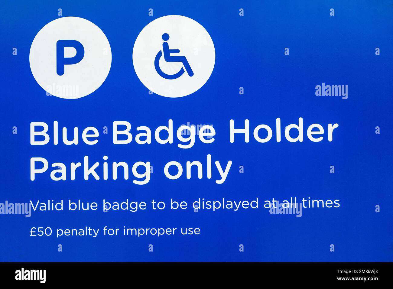 Blue badge holder parking warner sign UK Stock Photo