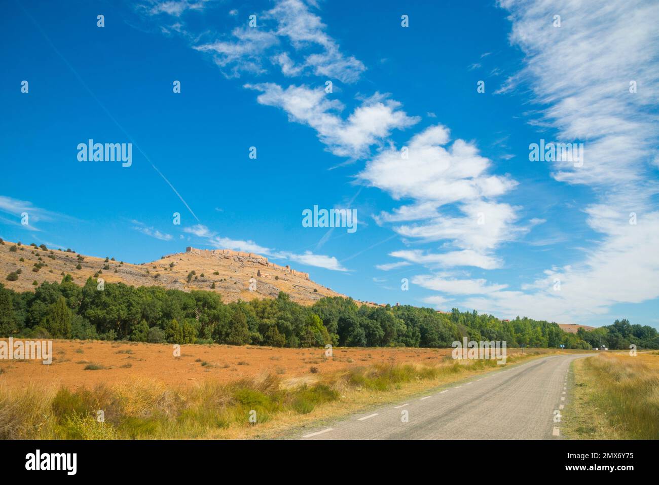 Road and castle. Gormaz, Soria province, Castilla Leon, Spain. Stock Photo
