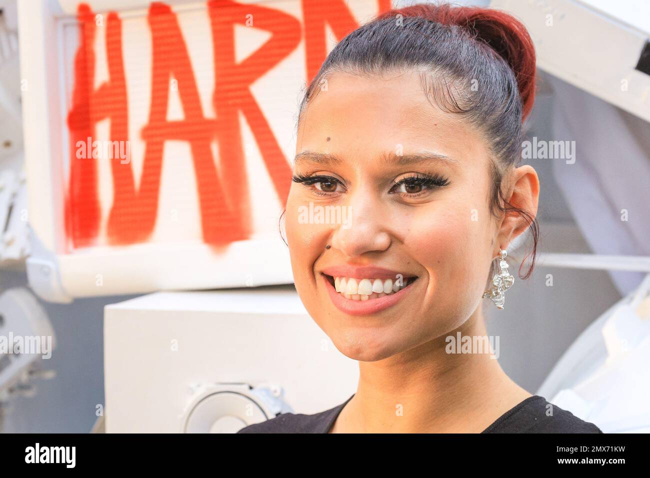 London, UK. 02nd Feb, 2023. Fresh from her recent UK No.1 single, singer Raye (RAYE), short for Rachel Agatha Keen, smiles and poses with an installation of her latest album cover at Kings Cross station, to coincide with the release of the new album, 'My 21st Century Blues'. Copyright: Imageplotter/Alamy Live News Stock Photo