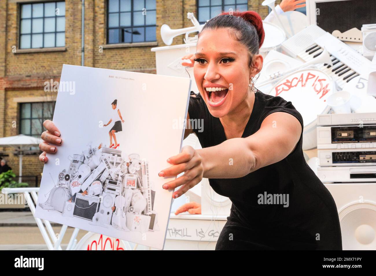 London, UK. 02nd Feb, 2023. Fresh from her recent UK No.1 single, singer Raye (RAYE), short for Rachel Agatha Keen, smiles and poses with an installation of her latest album cover at Kings Cross station, to coincide with the release of the new album, 'My 21st Century Blues'. Copyright: Imageplotter/Alamy Live News Stock Photo
