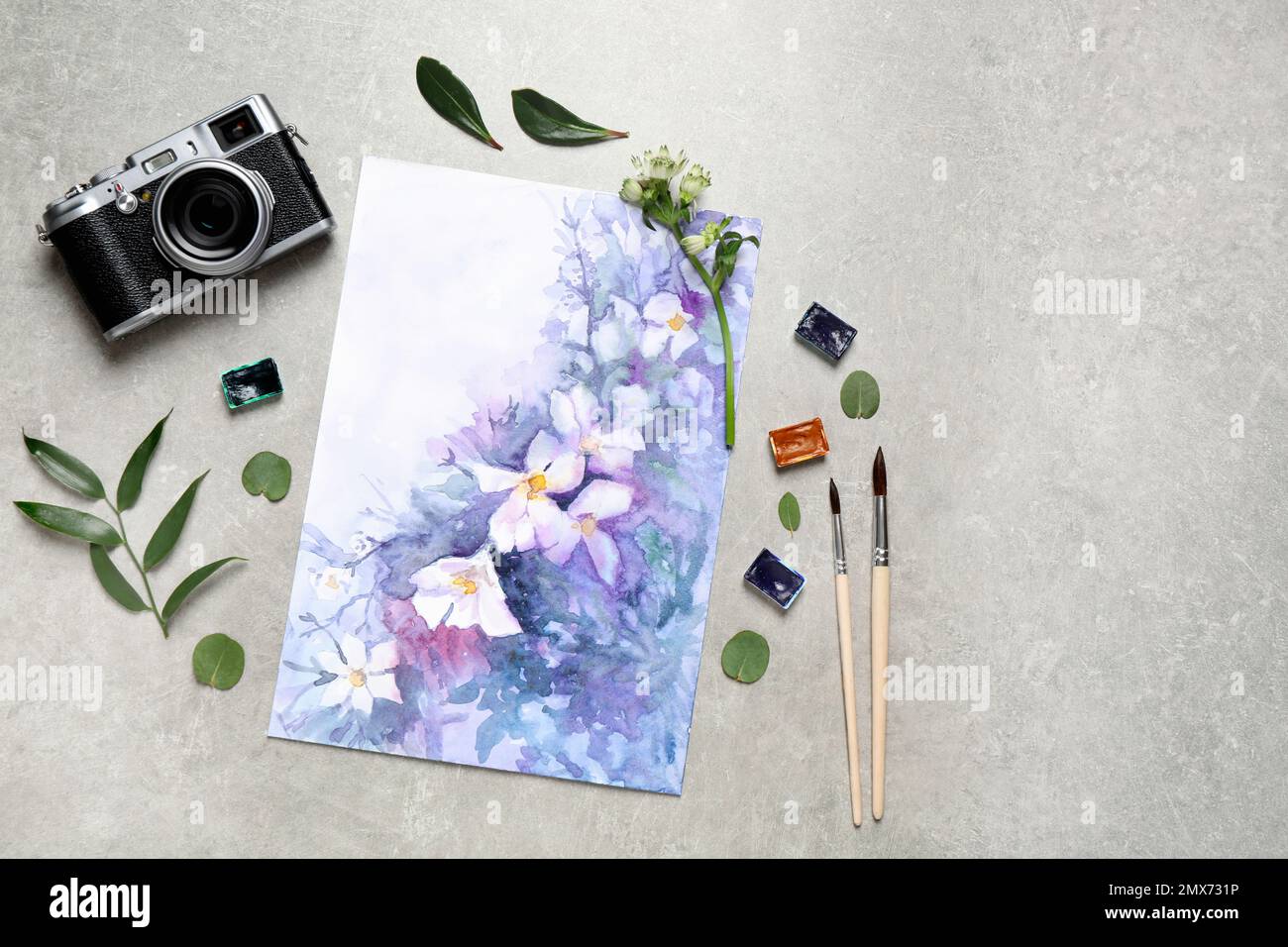 Flat lay composition with watercolor paints and floral picture on grey stone table Stock Photo