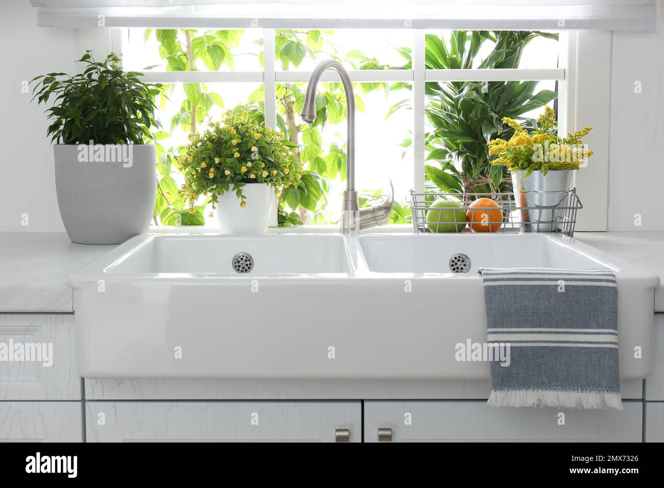 Beautiful white sink near window in modern kitchen Stock Photo - Alamy