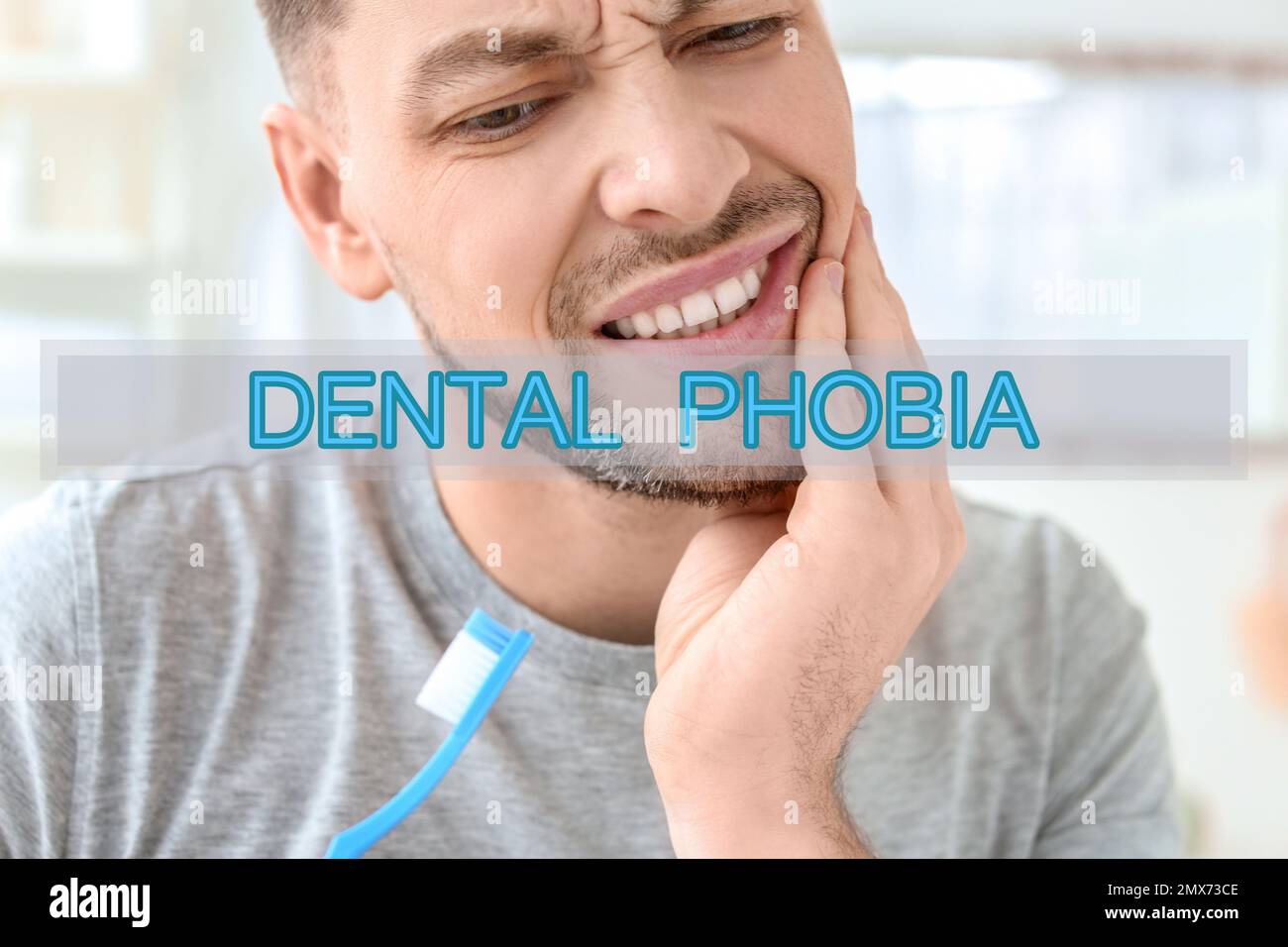 Dental phobia concept. Man suffering from toothache indoors Stock Photo