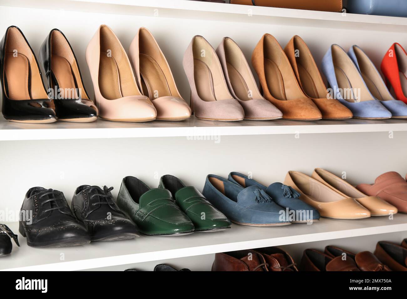 White shelving unit with different leather shoes Stock Photo Alamy