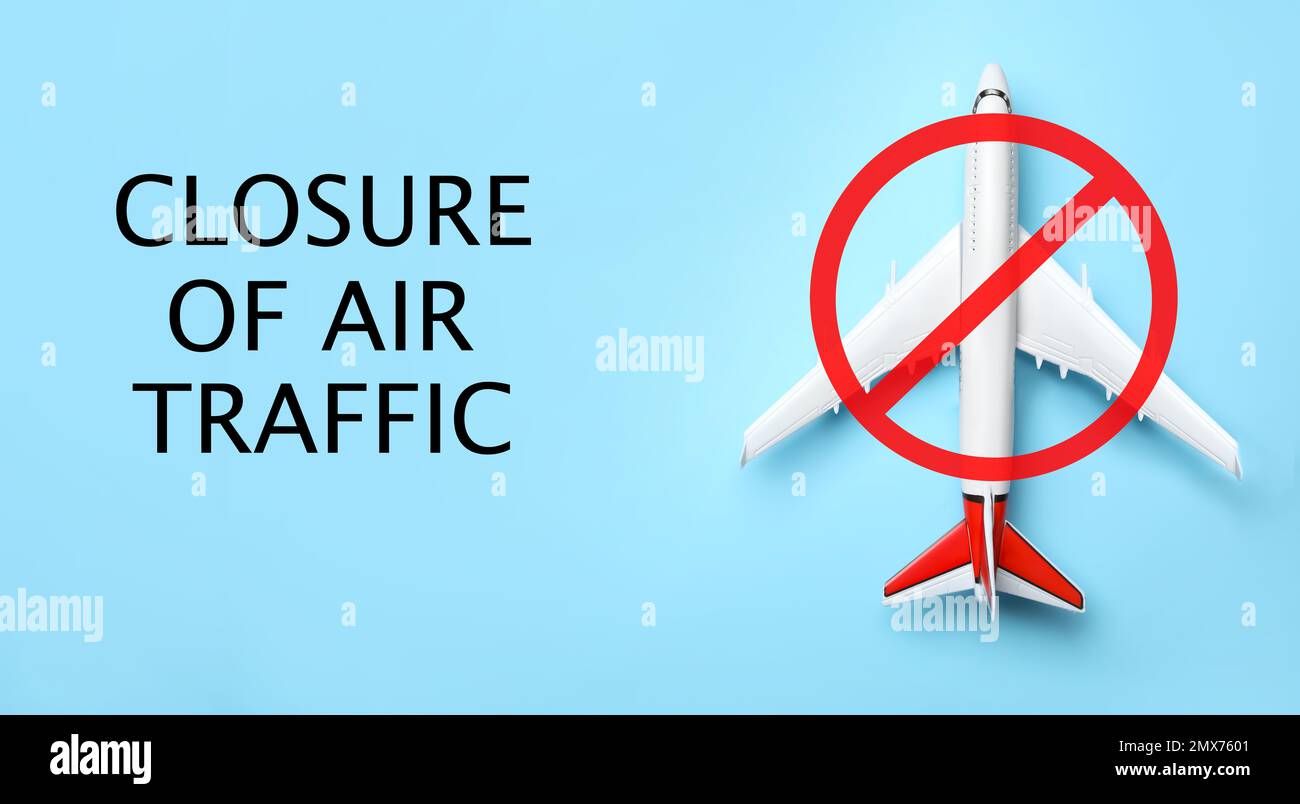 Closure of air traffic through quarantine during coronavirus outbreak. Airplane and prohibition sign on light blue background, top view Stock Photo