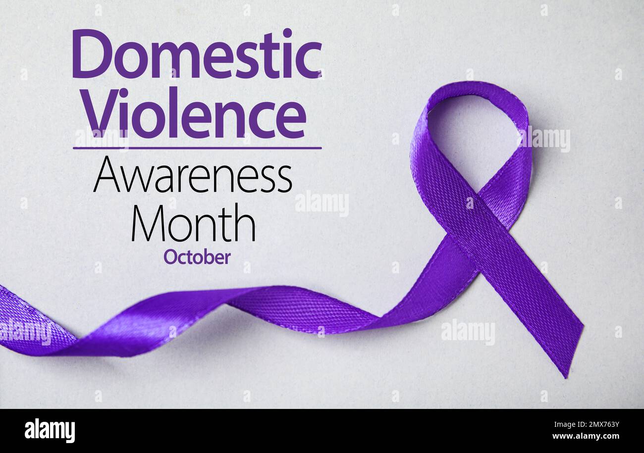 Purple ribbon on grey background, top view. Symbol of Domestic Violence Awareness Stock Photo
