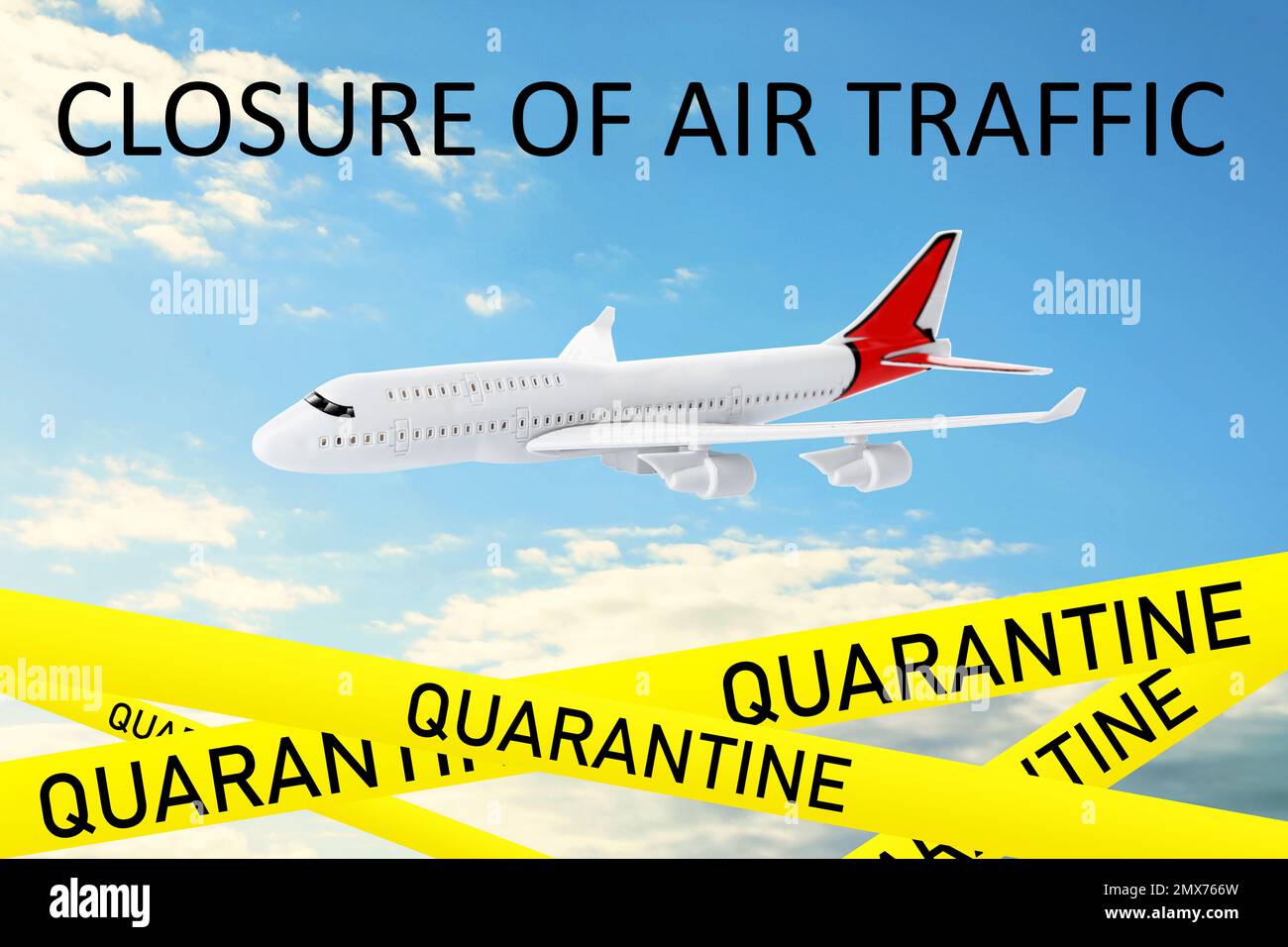 Closure of air traffic through quarantine during coronavirus outbreak. Airplane in blue sky and yellow awareness ribbons Stock Photo