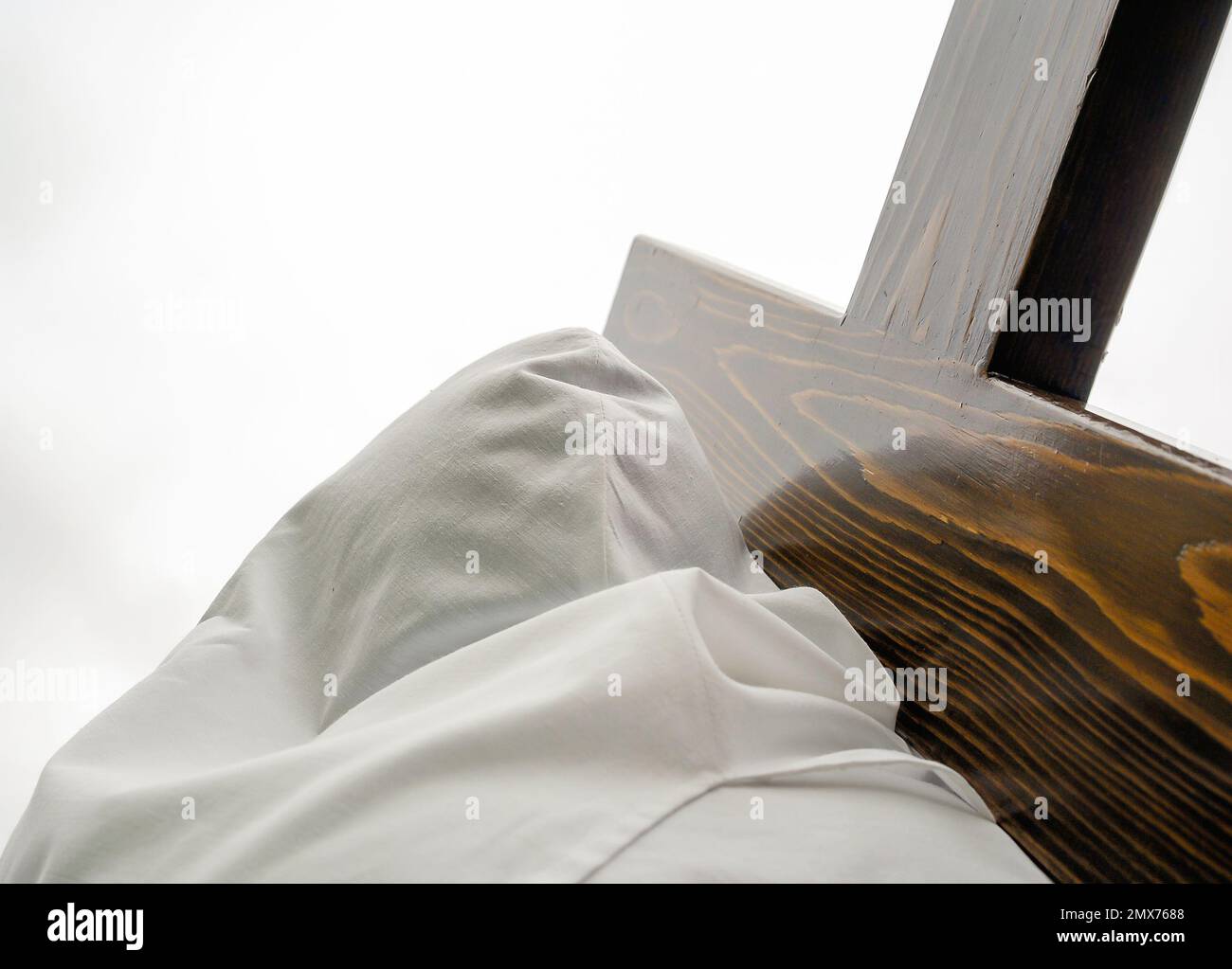 Holy Week in Zamora, Spain. View from below of the hood of a penitent carrying a cross in the procession of the holy burial in Bercianos of Aliste. Stock Photo