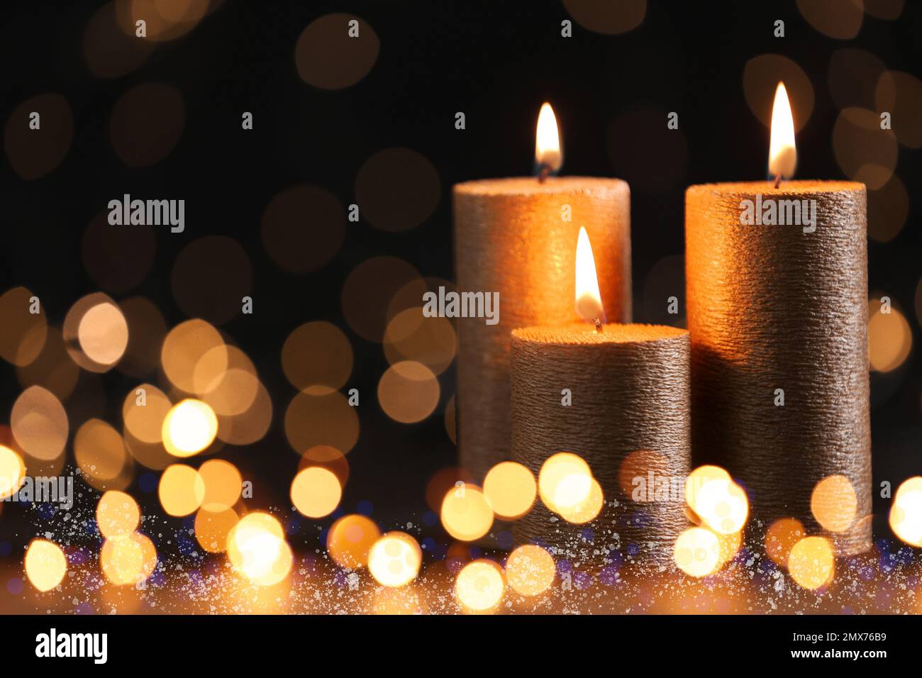 Burning candles on dark background, bokeh effect Stock Photo - Alamy