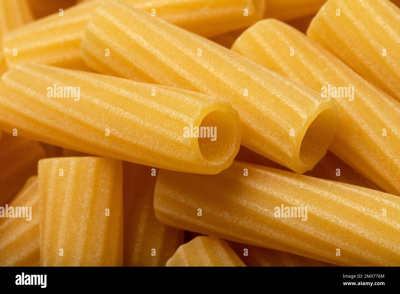 Uncooked rigatoni pasta. Food background. Close up of noodles Stock ...