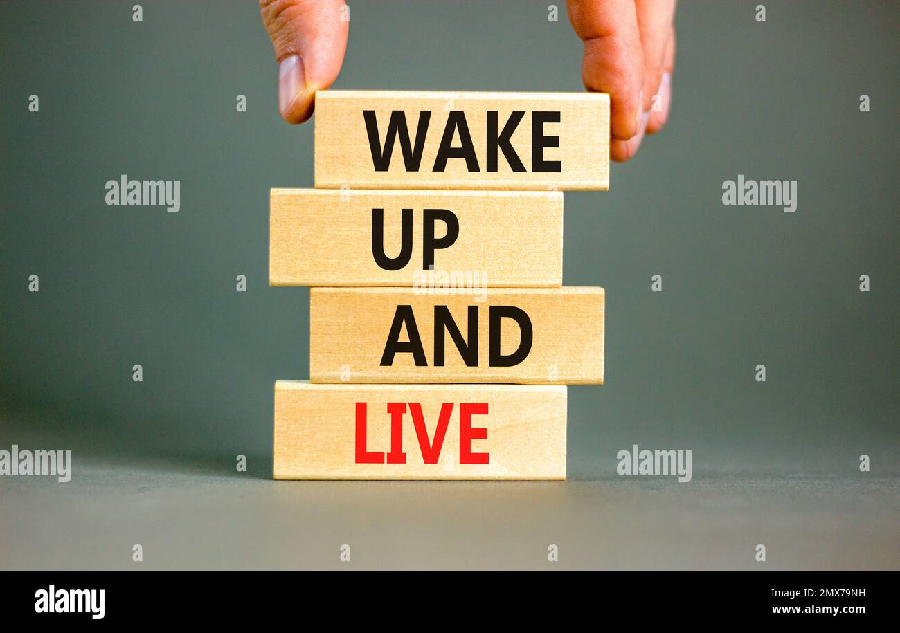 Wake up and live symbol. Concept words Wake up and live on wooden