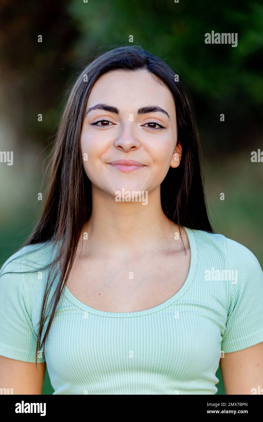 Brunette young beautiful teenager girl outside enjoying a beautiful day during the summer Stock Photo