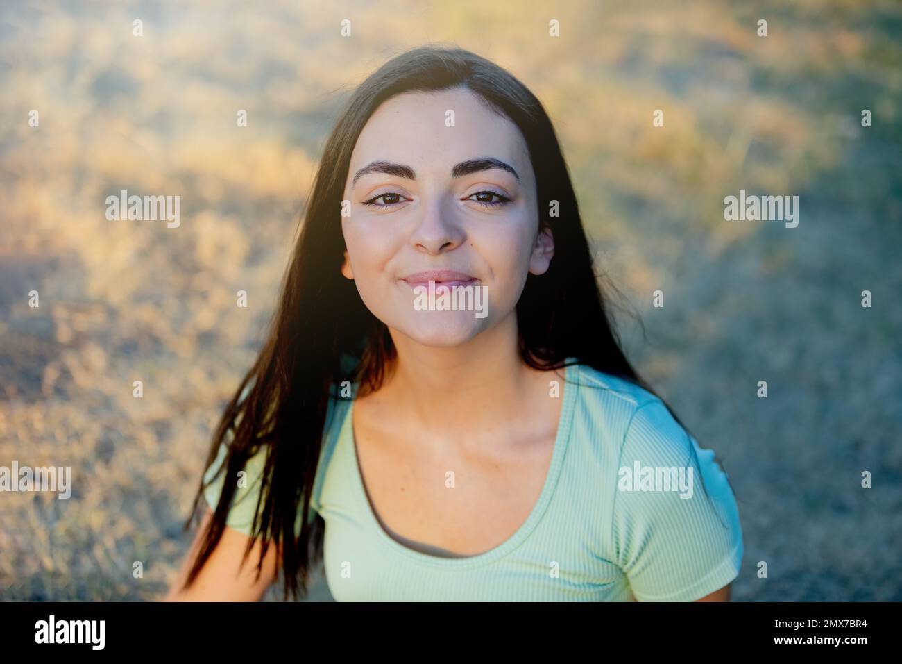 Brunette young beautiful teenager girl outside enjoying a beautiful day during the summer Stock Photo