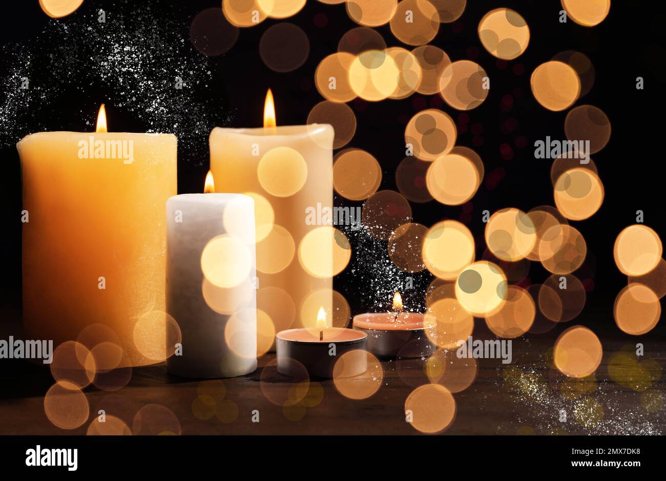 Burning candles on dark background, bokeh effect Stock Photo - Alamy