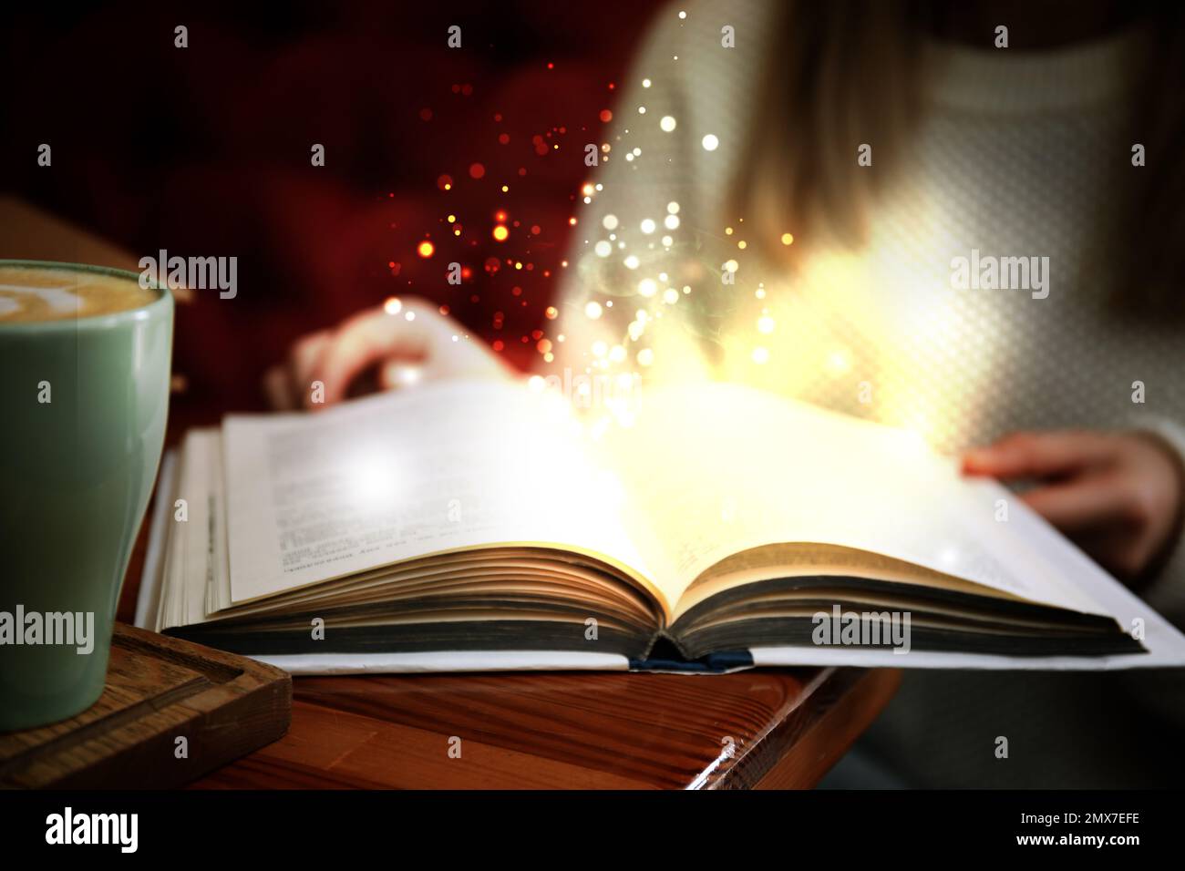Woman reading shiny magic book, closeup view Stock Photo