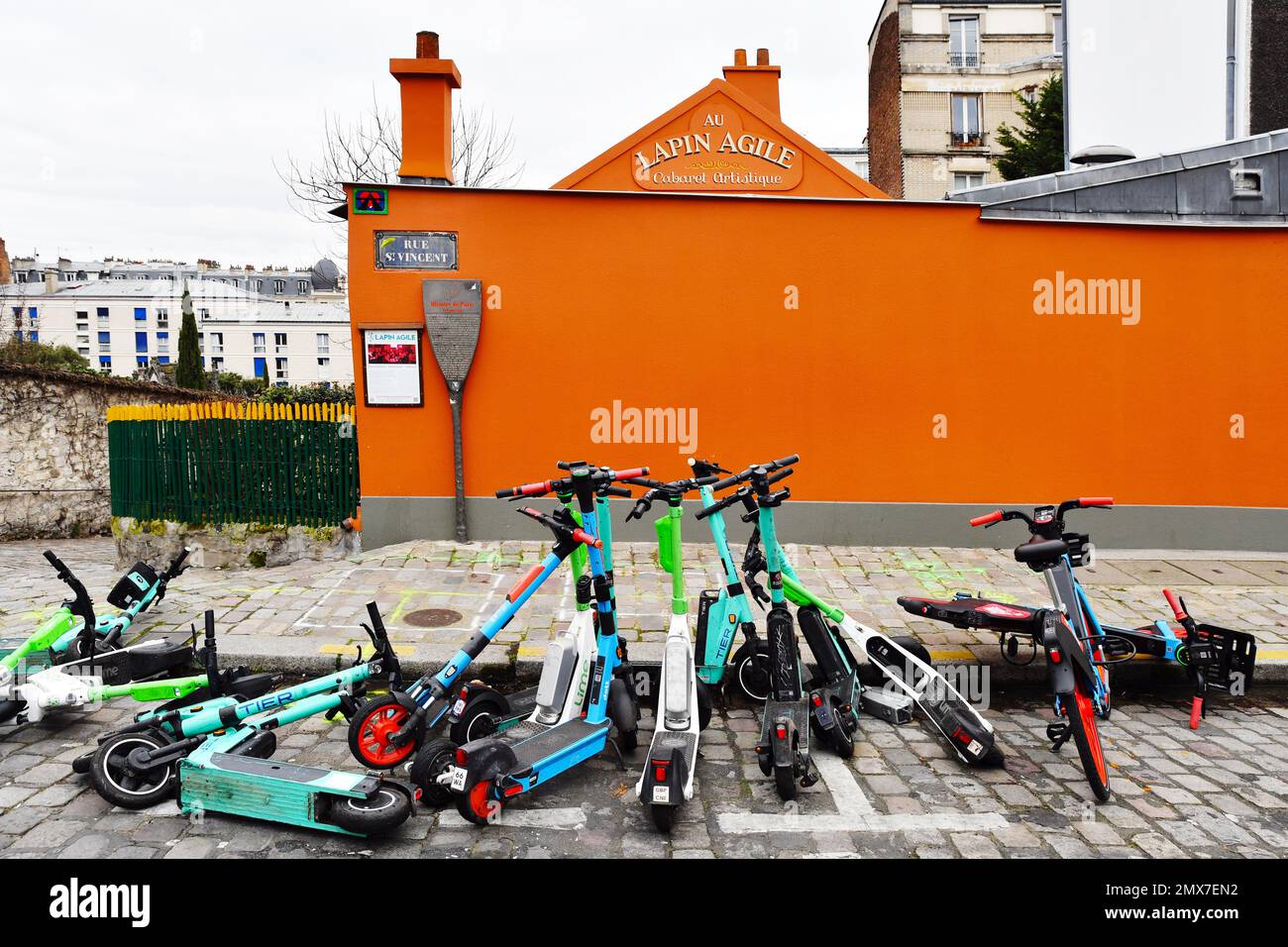 Group of escooters in front of le Lapin Agile Montmartre Paris