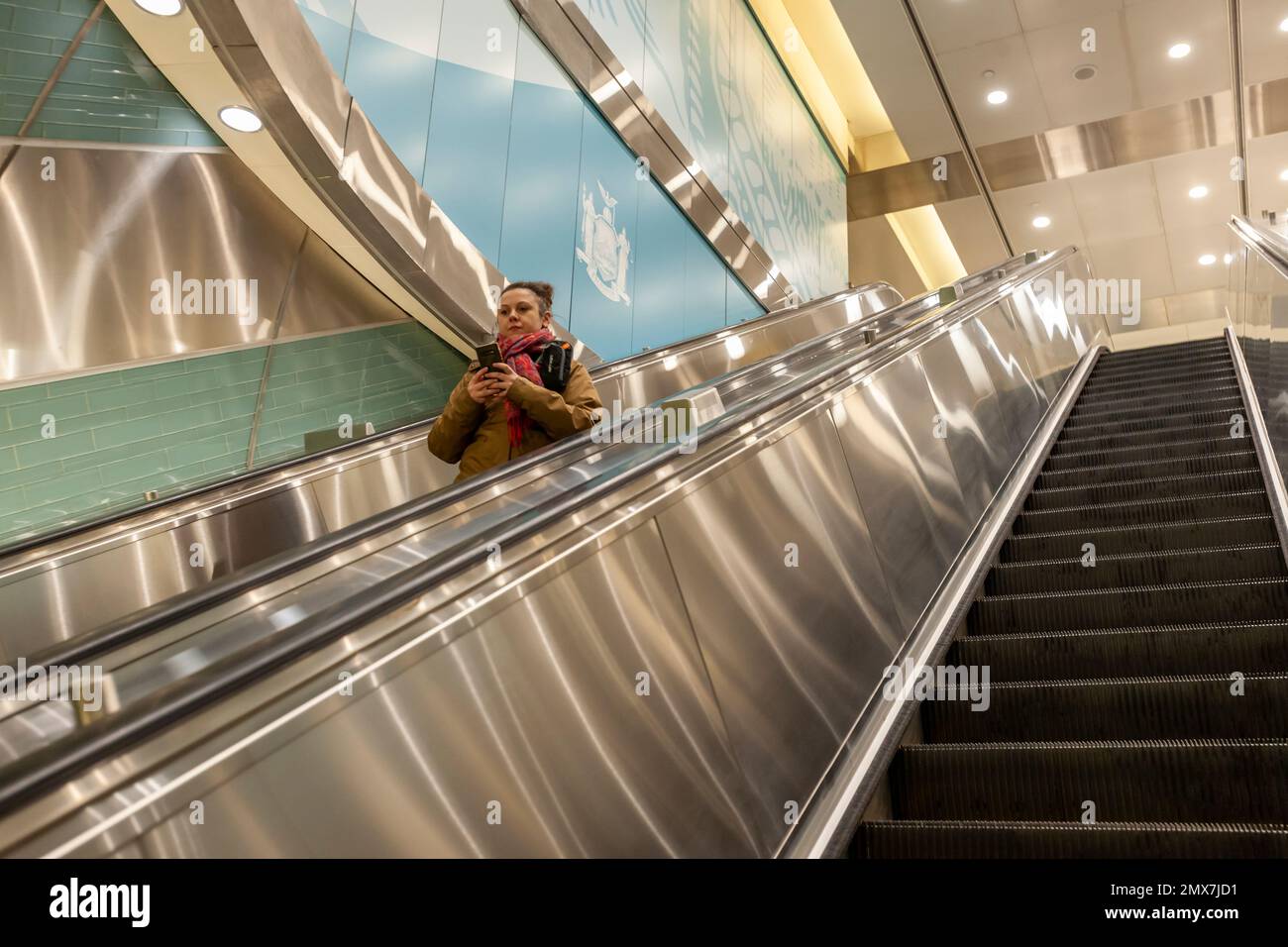 Visitor On An Escalator In Grand Central Madison Deep Under New York On visitor-on-an-escalator-in-grand-central-madison-deep-under-new-york-on
