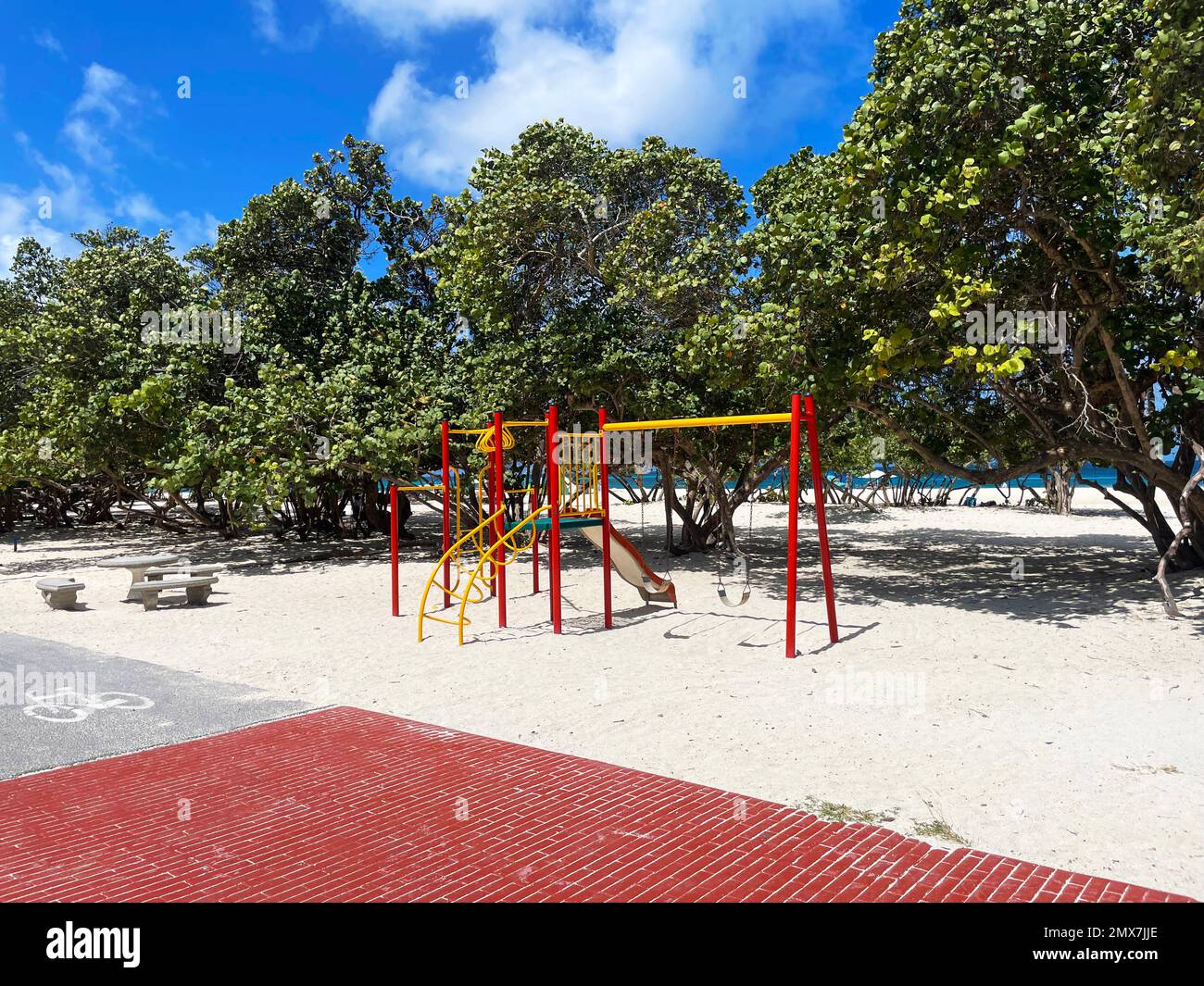A small childs playset, with swings and a slide, on the beach, Eagle Beach, Aruba. Stock Photo