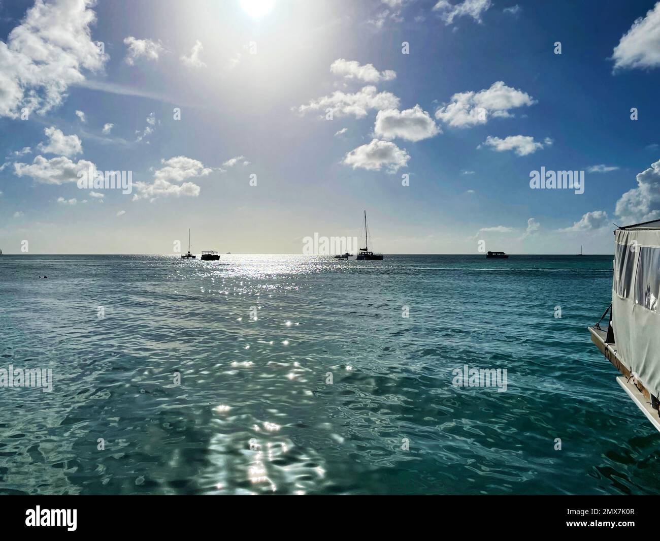 Boats on the Caribbean sea, off the coast of Aruba. Stock Photo