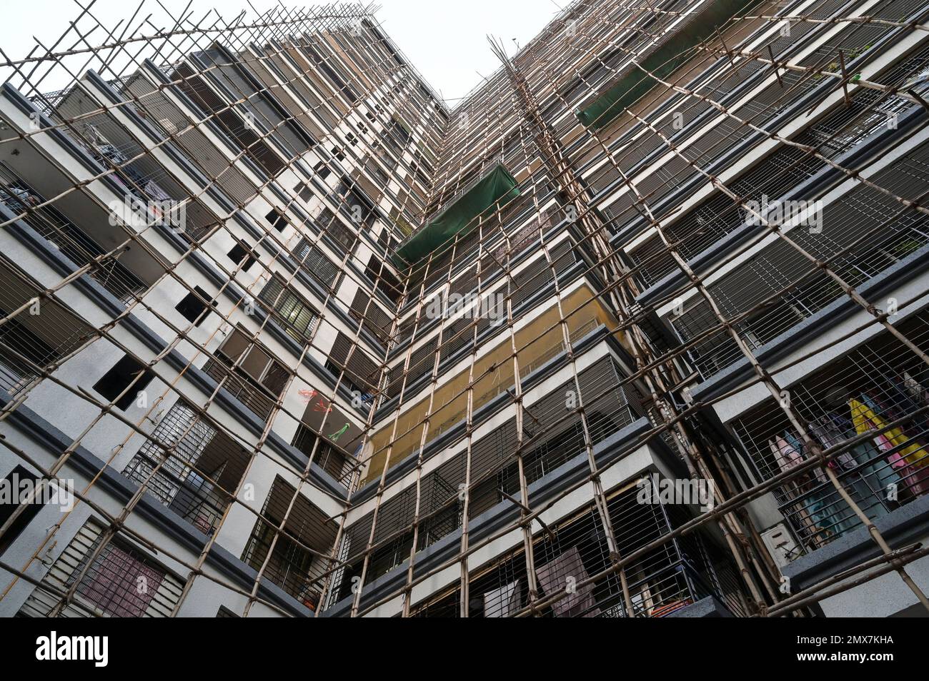 Image showcasing INDIA, Mumbai, apartment tower under renovation, Scaffolding with ...