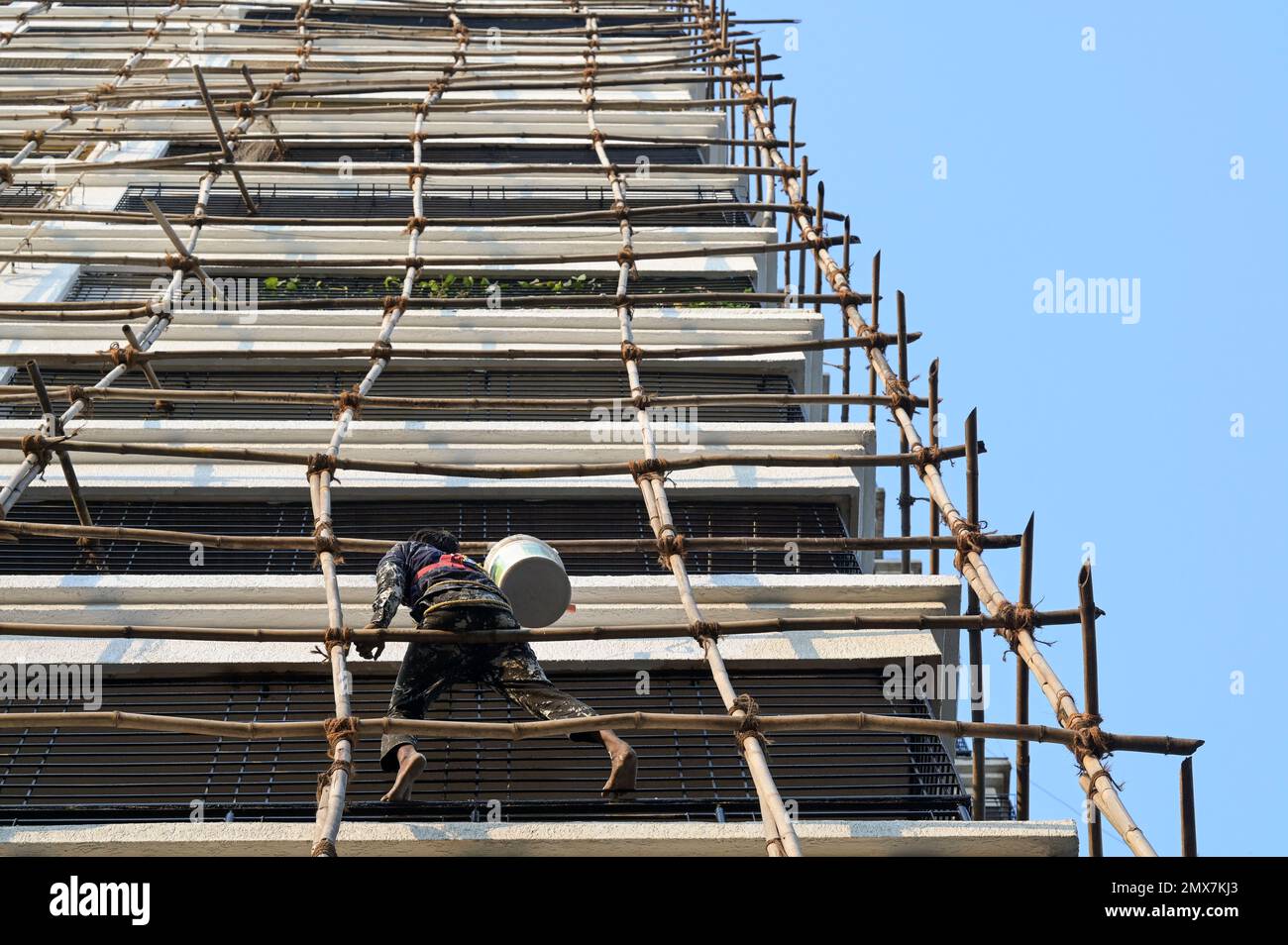INDIA, Mumbai, apartment tower under renovation, bamboo scaffold ...