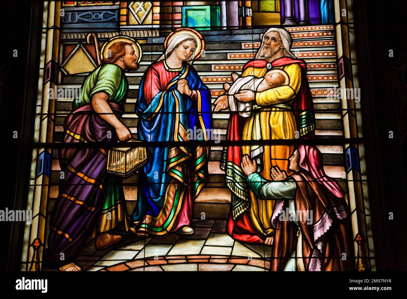 Stained glass window with religious scene showing Joseph and the Virgin