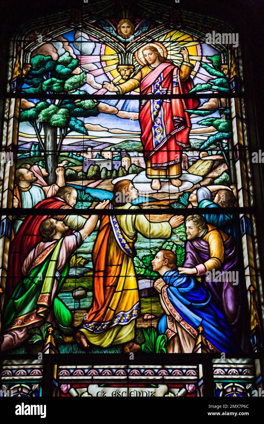 Stained glass window with religious scene showing Jesus and worshippers